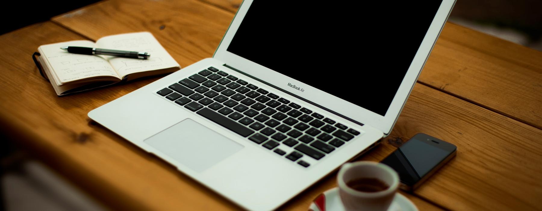 a laptop and a cup of coffee on a table