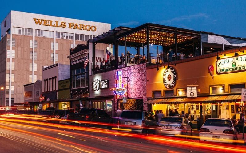 a street with cars and buildings along it