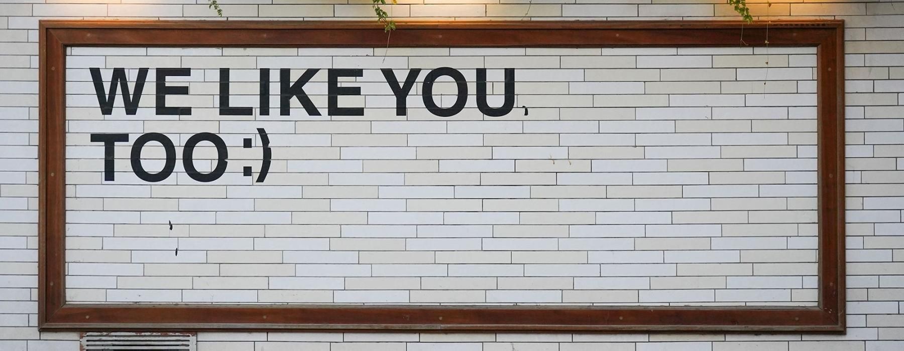 a sign on a tile wall that says, 